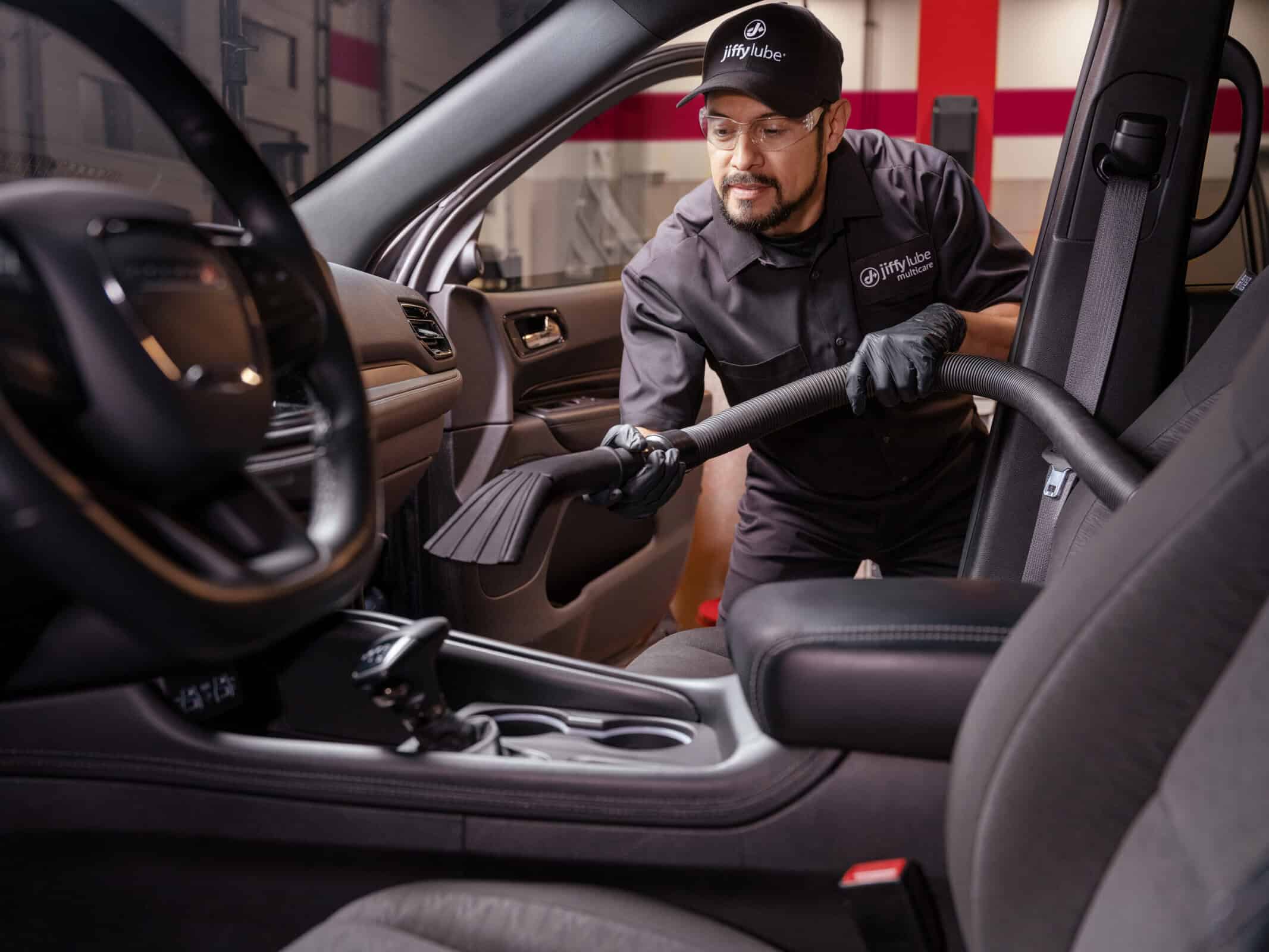 man vacuuming out car